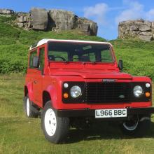 Land rover Defender is on the grass at Ilkley moor