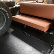 Rear bench seats with tan material can be fitted in the rear of land rover's