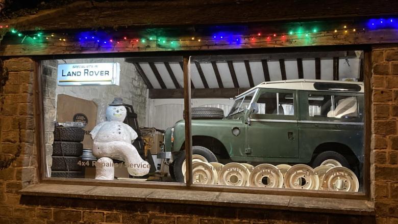 A snowman is seen here in our land rover showroom