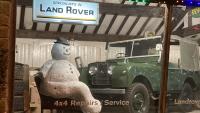 An imitation snowman is sitting in the land Rover showroom next a series one Land Rover